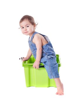 Kid plays with plastic container isolated on white