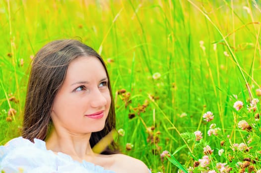 portrait of a girl in green grass and clover