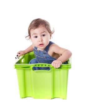 Kid plays with plastic container isolated on white