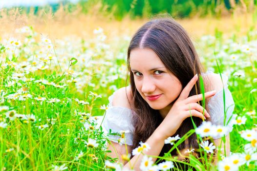 playful look girls in camomile field