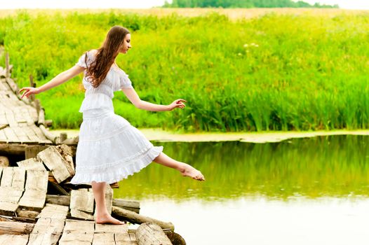 girl on the bridge balances on one leg