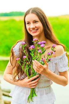 beautiful smiling happy girl with a bouquet