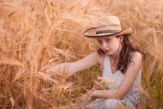 Woman in the wheat field, farmer with crop