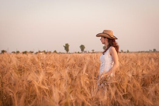 Woman in the wheat field, farmer with crop