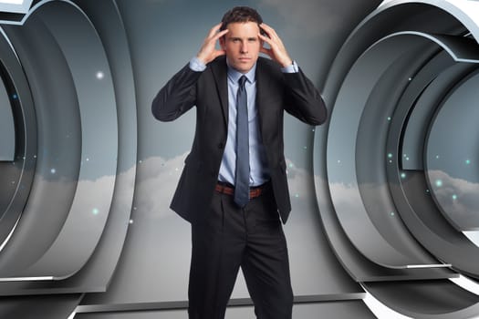 Stressed businessman with hands on head against abstract cloud design