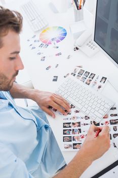 High angle view of a male photo editor at work in the office