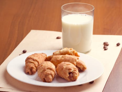 Croissant and milk on  wooden table