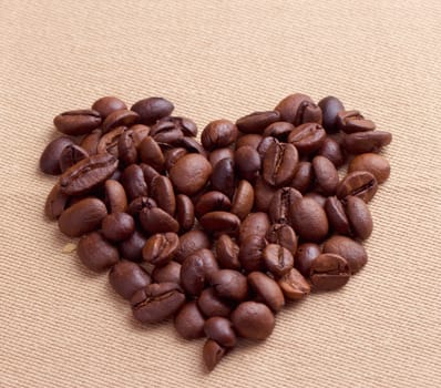 heart form coffee beans, on wooden surface