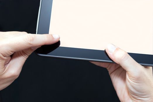 Close-up of a finger swiping a tablet,