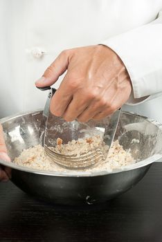 Close-up of a pastry chef preparing a crust