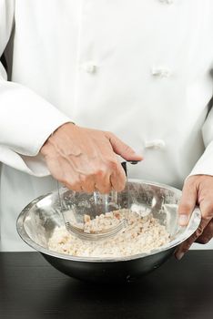 Close-up of a pastry chef preparing a crust