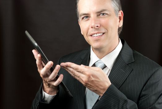 Close-up of a businessman showing his tablet.