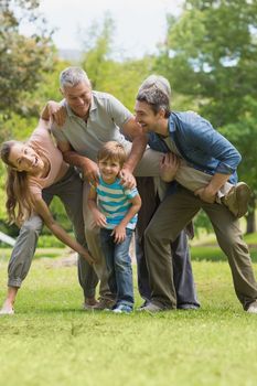 Cheerful family playing in the park