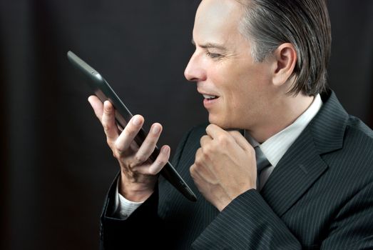 Close-up of a businessman admiring his tablet.