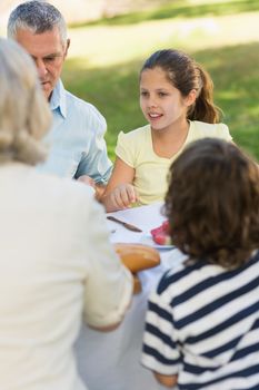 View of family dining at outdoor table