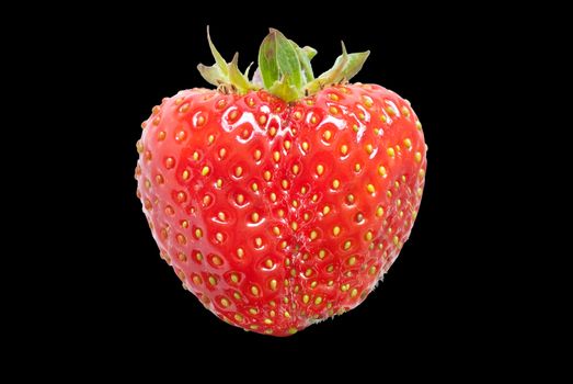 Close-up of a ripe red strawberry on black.