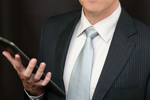 Close-up of a businessman holding a tablet