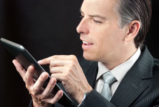 Close-up of a businessman using a tablet.