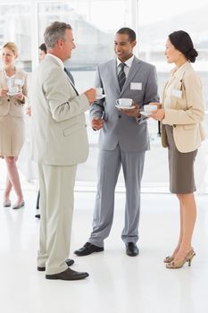 Business people talking and drinking coffee at a conference in the office