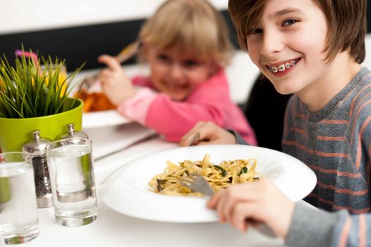 Siblings enjoying meal in a restaurant