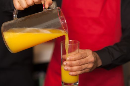 Closeup shot of a guy with fresh juice glass