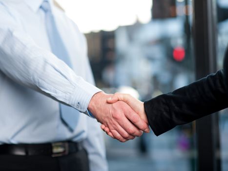 Successful business people shaking hands after closing a deal