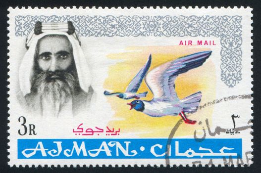 AJMAN - CIRCA 1964: stamp printed by Ajman, shows Sheik Rashid bin Humaid al Naimi and bird, circa 1964