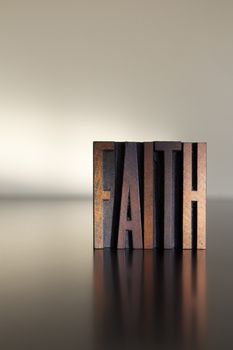 The word FAITH written in vintage letterpress type