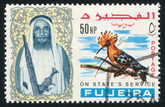 FUJEIRA - CIRCA 1976: stamp printed by Fujeira, shows a Man and a Bird, circa 1976