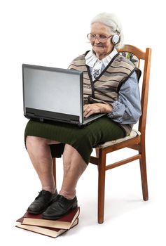 Senior woman using laptop computer isolated on white