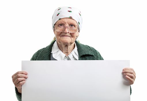 Smiling elderly lady holding blank sheet in hands over white