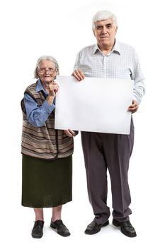 Senior woman and mature man holding a blank billboard isolated on white background
