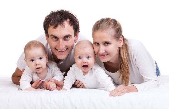 Closeup of young family with two baby boys against white background