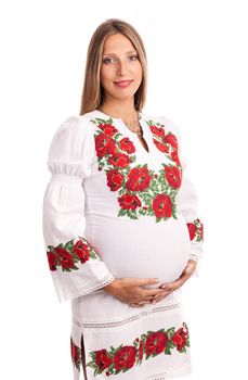 Beautiful pregnant woman in Ukrainian style dress over white background