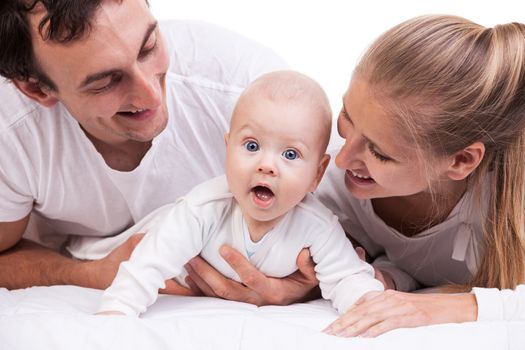 Closeup of young family with baby boy against white background