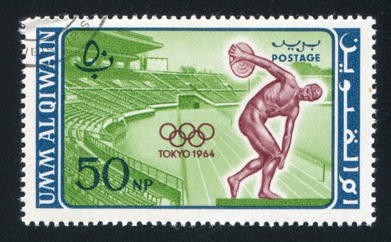 UMM AL-QUWAIN - CIRCA 1964: stamp printed by Umm al-Quwain, shows Stadium and Discobolus, circa 1964