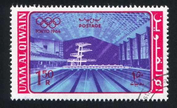 UMM AL-QUWAIN - CIRCA 1964: stamp printed by Umm al-Quwain, shows Olympic Swimming Pool, circa 1964