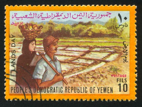 YEMEN - CIRCA 1972: stamp printed by Yemen, shows Farm Couple and Fields, circa 1972