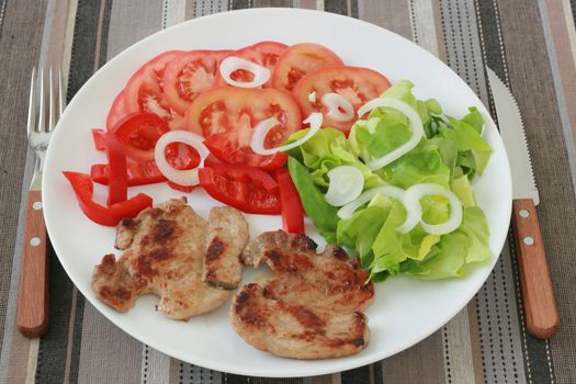 fried pork with salad on the plate