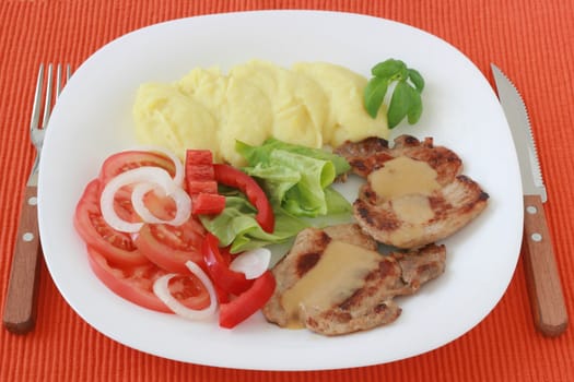 fried pork with mashed potato and salad