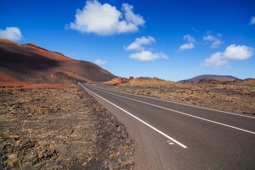 Driving in Lanzarote with view to Timanfaya volcanoes, Canary, Spain. Panorama