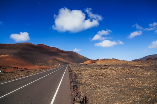 Driving in Lanzarote with view to Timanfaya volcanoes, Canary, Spain. Panorama