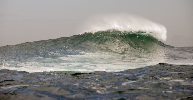 Ocean  with big wave on cloudy day. 