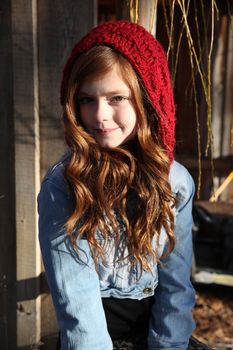 Teen winter girl wearing a red hat