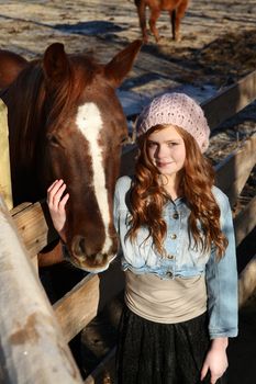 Teen girl outdoors on farm with horses