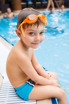 Activities on the pool. Cute boy in swimming pool