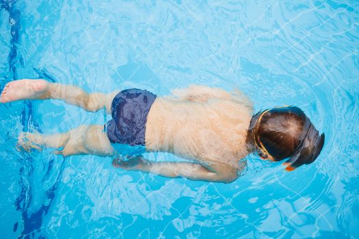 Activities on the pool. Cute boy in swimming pool