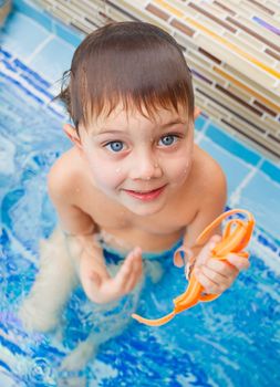 Activities on the pool. Cute boy in swimming pool