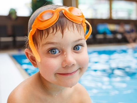 Activities on the pool. Cute boy in swimming pool