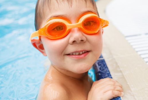 Activities on the pool. Cute boy in swimming pool